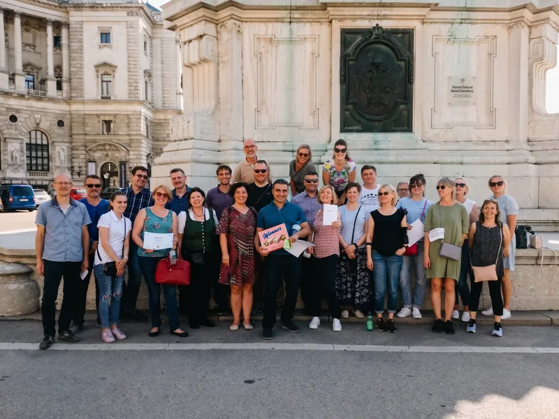 Team members studying a treasure hunt map together in Vienna
